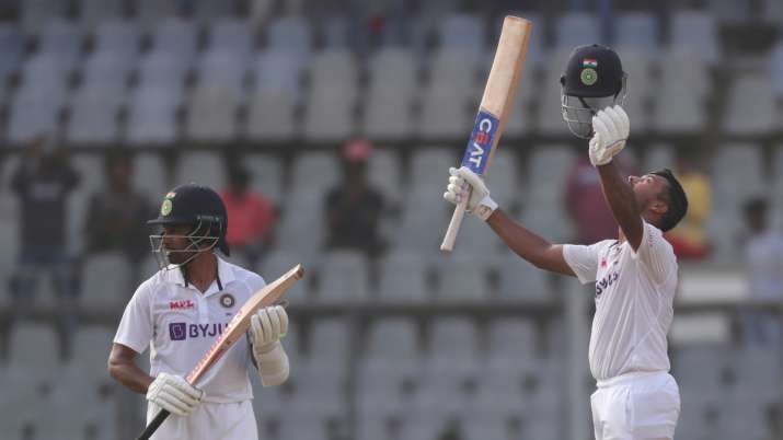 India's Mayank Agarwal , left, celebrates scoring a century during Day 1 of the Mumbai Test against 