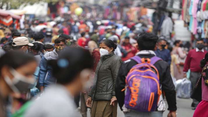 A police woman wearing mask, center, stands to direct