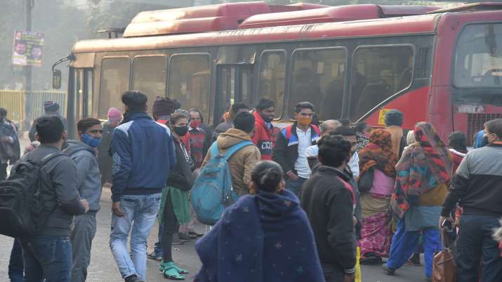 India Tv - Passengers wait to board buses as DTC buses are operating at 50 percent capacity in the wake of rising Covid-19 cases of Omicron variant, in New Delhi, Wednesday, Dec. 29, 2021. 