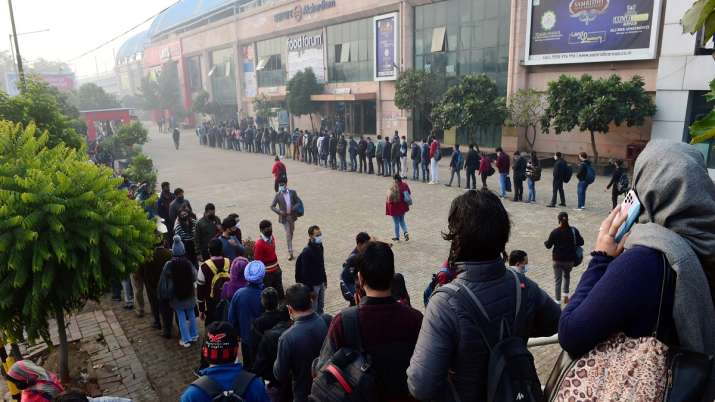 India Tv - Passengers queue outside Akshardham Metro station in New Delhi, Wednesday, December 29, 2021.