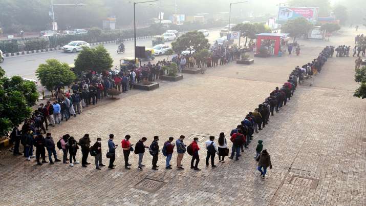 India Tv - Passengers queue outside Akshardham Metro station in New Delhi, Wednesday, December 29, 2021. 