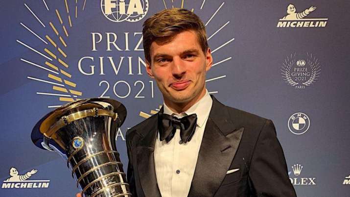 Max Verstappen posing with champion's trophy At the FIA Awards. 