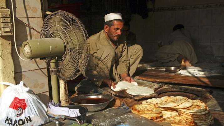 A man bakes local bread at a bakery in Peshawar, Pakistan.