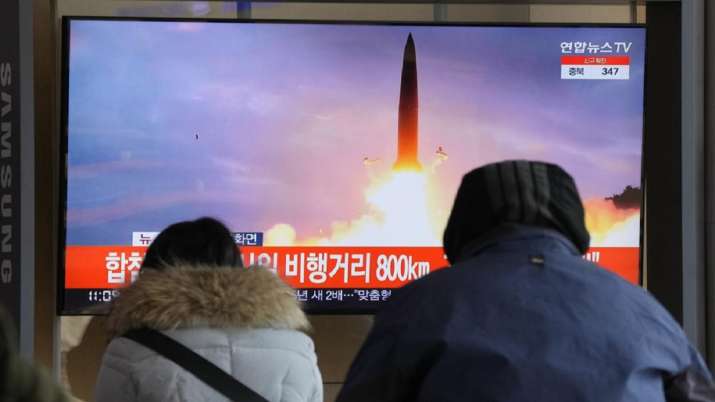 People watch a TV showing a file image of North Korea's