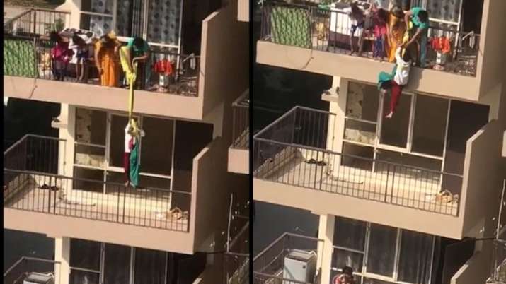 Viral video, trending, trending news india, Mother hangs child from 10th floor, Faridabad