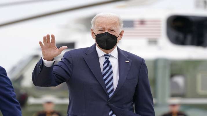 President Joe Biden waves as he boards Air Force One upon