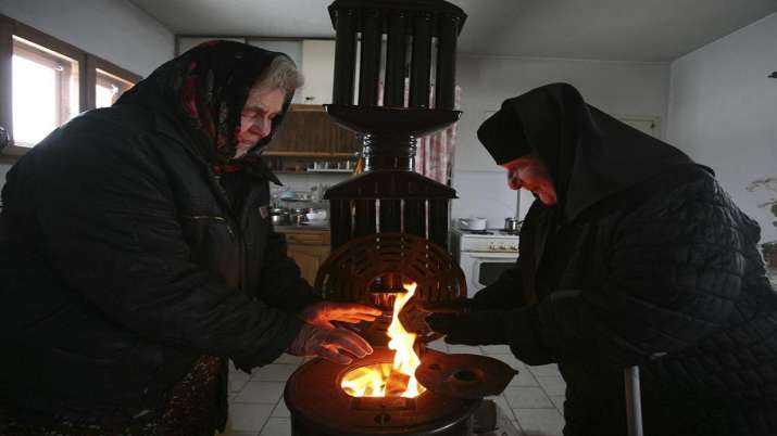 India Tv - A nun and visitor try to stay warm near a wood-burning stove in a monastery near the Bulgarian capital Sofia, Friday, Jan. 9, 2009. Fears are rising about what would happen to Europe’s energy supply if Russia were to invade Ukraine and then shut off its natural gas in retaliation for U.S. and European sanctions.