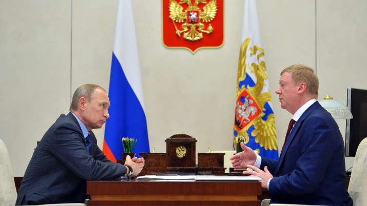 Russian President Vladimir Putin, left, listens to RUSNANO