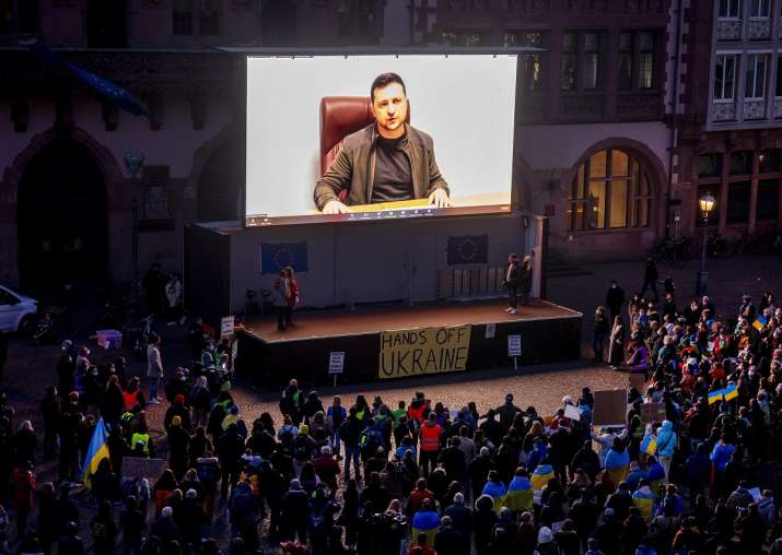 India Tv - Ukraine's President Volodymyr Zelensky delivers a video message to people attending a rally at Remember Square on March 4, 2022 in Frankfurt, Germany. 