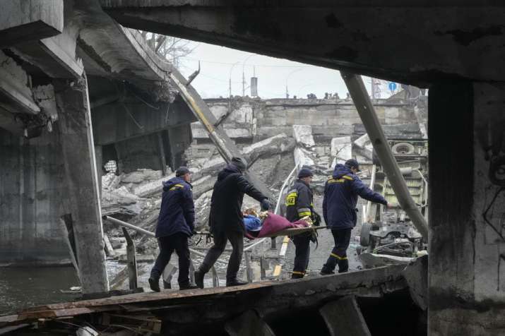 Ukrainian rescuers take down an elderly woman