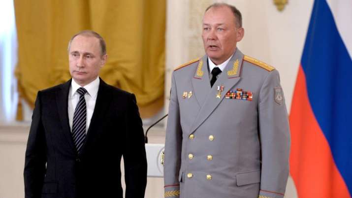 Russian President Vladimir Putin, left, posing with Col.