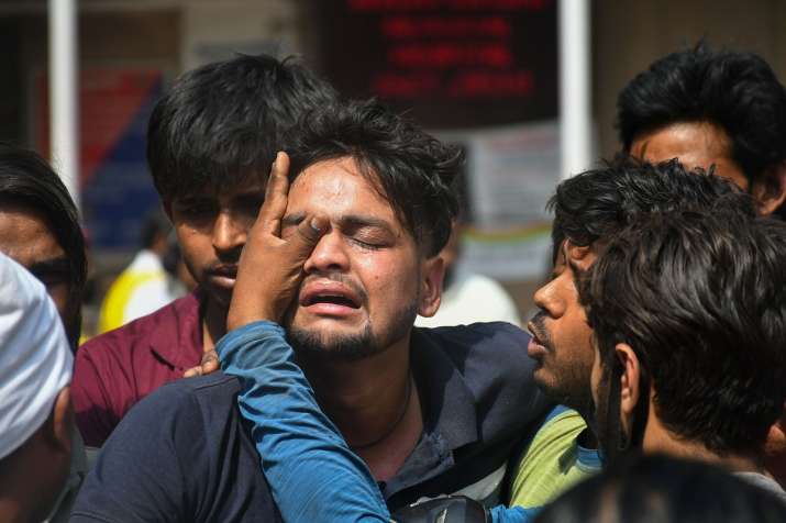 India Tv - Family members of the missing people who are unsure about their whereabouts react after a massive fire at an office building near the Mundka Metro Station, outside Sanjay Gandhi Memorial Hospital in New Delhi