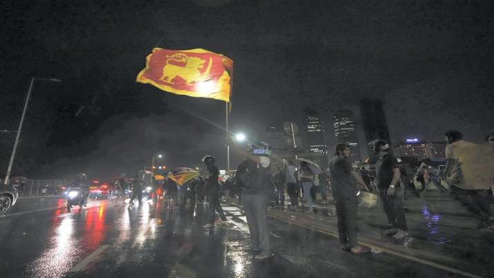 Sri Lankans shout anti government slogans during a protest