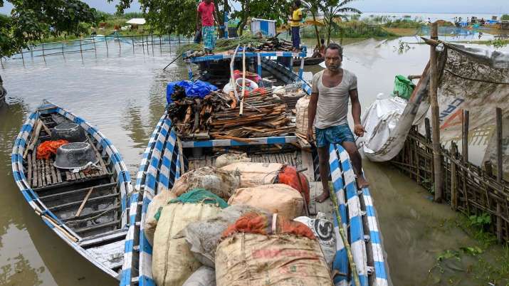 Flood affected villagers use boats to go to safer areas