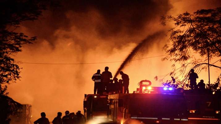 Firefighters try to douse a fire, that broke out in a