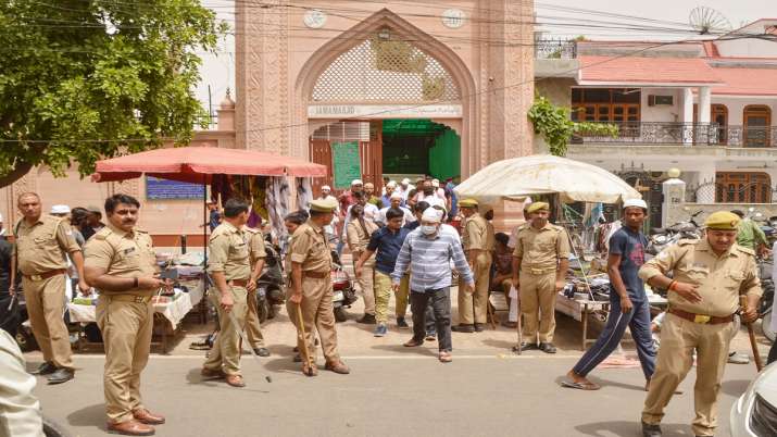 Muslim devotees come out of a mosque after the Friday offering