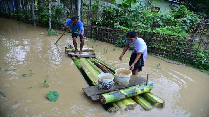 Villagers use banana raft to cross a flooded road