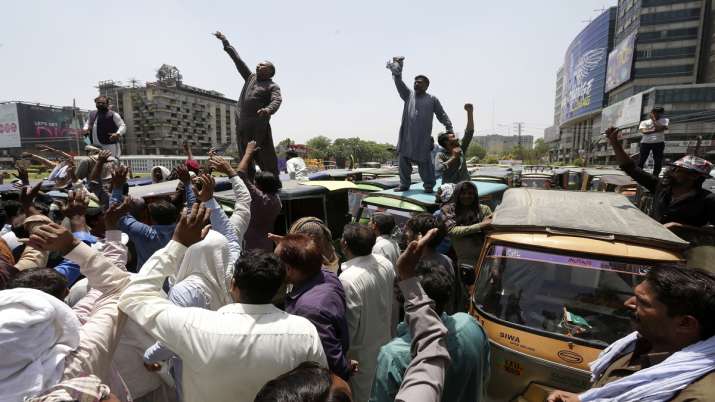 Pakistani rickshaw drivers chant slogans during a protest