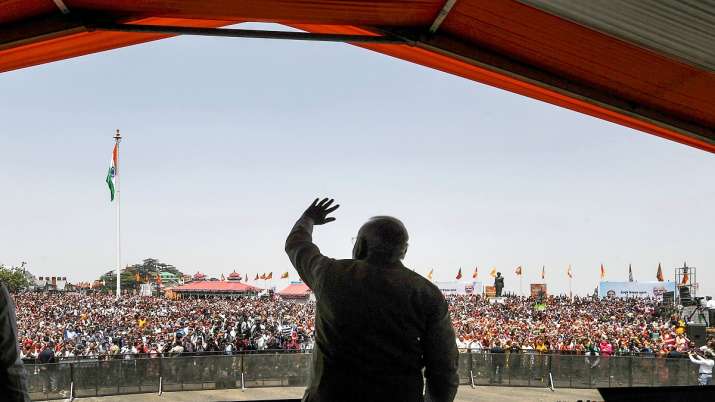 Prime Minister Narendra Modi shaking hands on the crowd during a