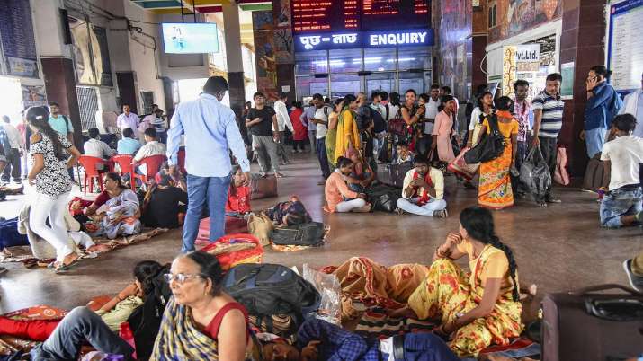 India Tv - Patna: Passengers wait at a railway station after several trains got cancelled due to protests against Centres Agnipath scheme, in Patna, Friday, June 17, 2022.
