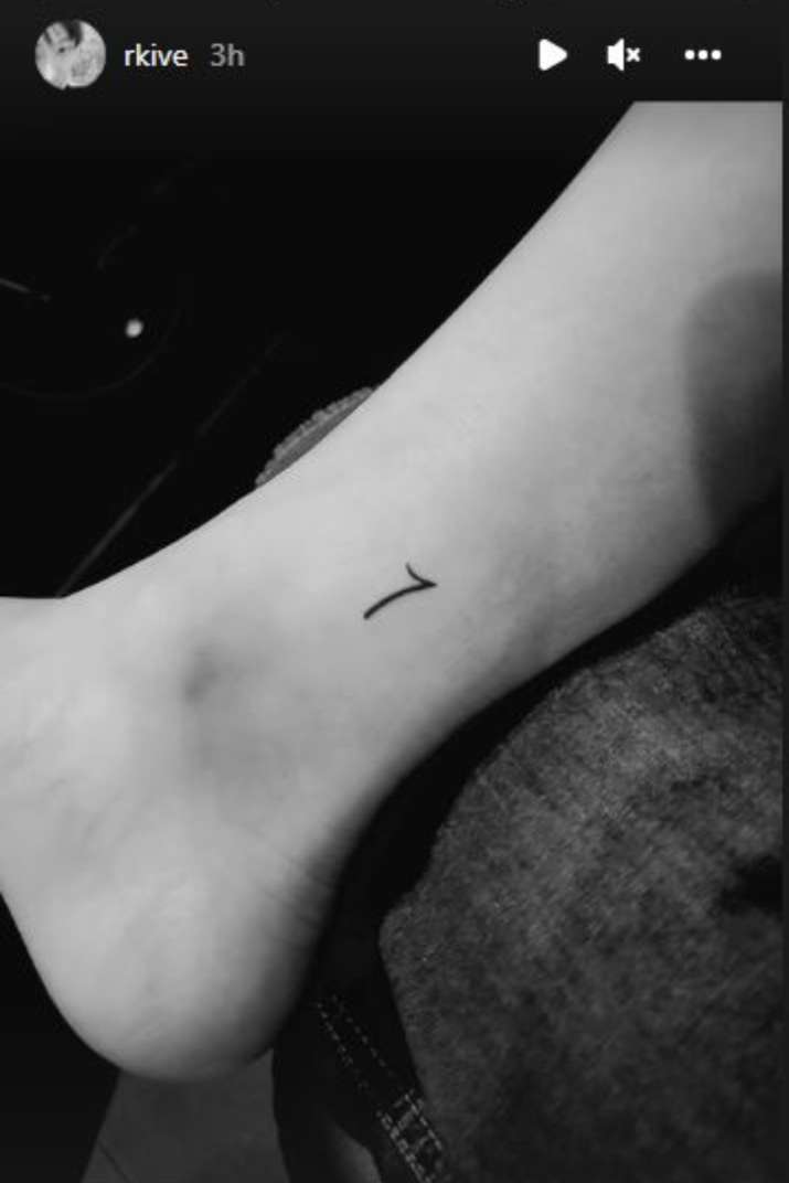 Minimalistic letter V tattoo for her son