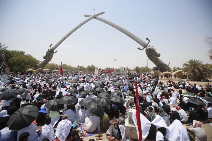 India Tv - Followers of Shiite cleric Muqtada al-Sadr gather during an open-air Friday prayers at Grand Festivities Square within the Green Zone, in Baghdad