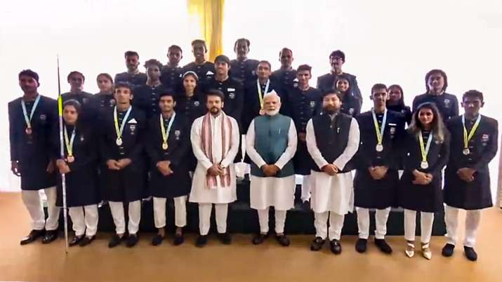 India Tv - Prime Minister Narendra Modi, Union Minister for Youth Affairs and Sports Anurag Thakur and Union Minister of State for Youth Affairs and Sports Nisith Pramanik pose for a photograph with members of the Indian contingent for the Commonwealth Games 2022 in New Delhi, Saturday, August .13, 2022.