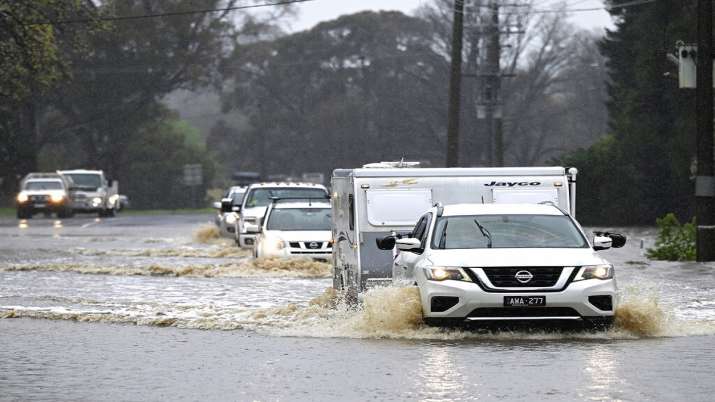 India Tv - Cars glide through a flooded road in Heathcote, Victoria state, Australia