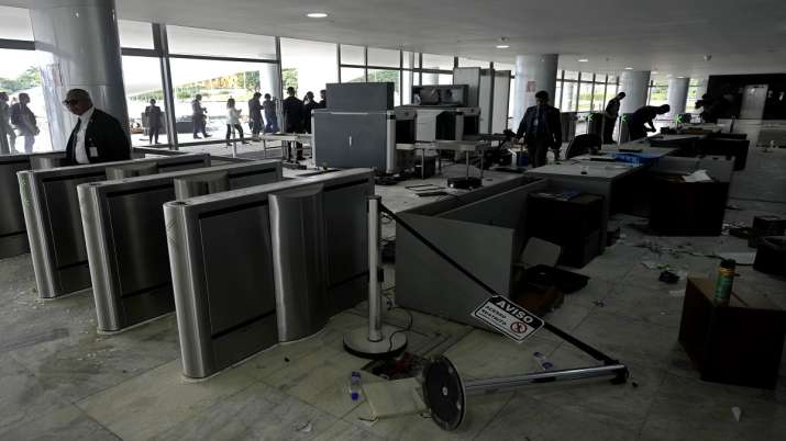 India Tv - Workers inspect destroyed computers in the main entrance of Planalto Palace, the office of the president, the day after it was stormed by supporters of Brazil's former President Jair Bolsonaro in Brasilia, Brazil