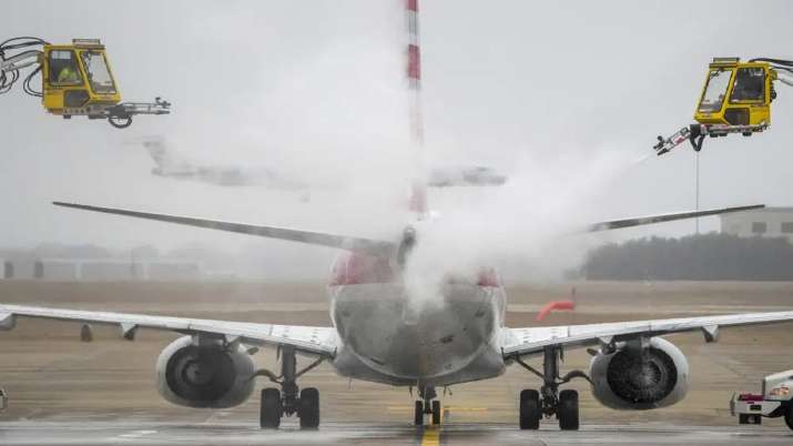 India Tv - An American Airlines aircraft undergoes deicing procedures at Dallas/Fort Worth International Airport in Texas