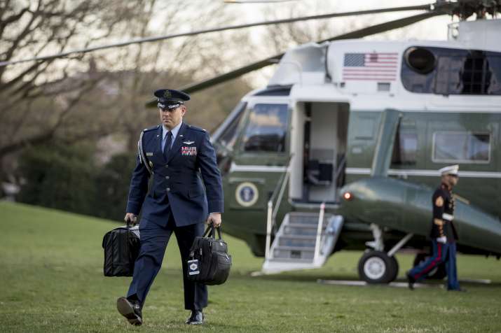 India Tv - A U.S. military aide carries the Presidential Emergency Satchel across the South Lawn of the White House in Washington, Sunday, March 31, 2019