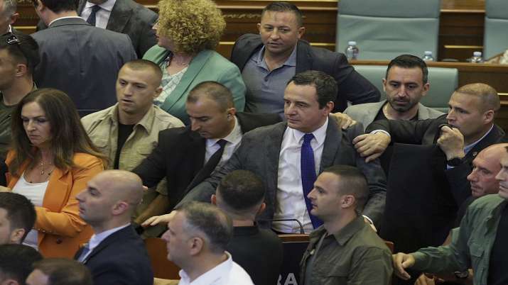 India Tv - Bodyguards guard Kosovo Prime Minister Albin Kurti, center, during a brawl breaks out in Kosovo's parliament in Pristina, Kosovo