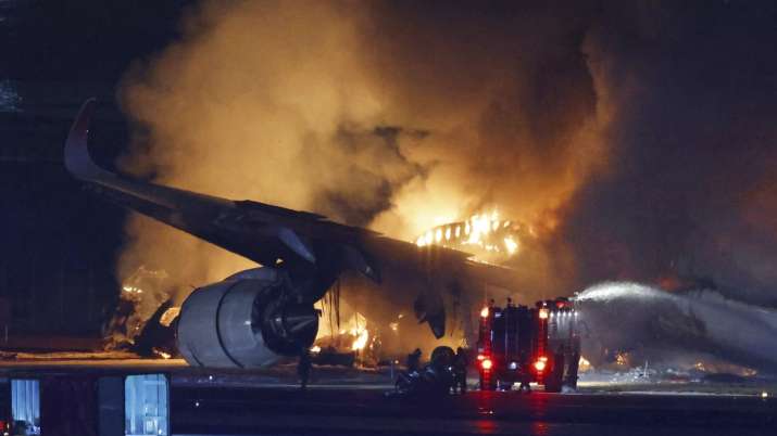 India Tv - Firefighters at work in Tokyo after the plane crash.