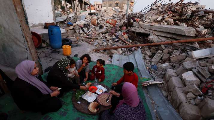 India Tv - Palestinians break their fast amid the rubble of their destroyed home during the Muslim holy fasting