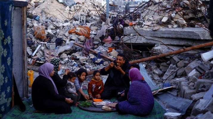 India Tv - Palestinians break their fast amid the rubble of their destroyed home during the Muslim holy fasting