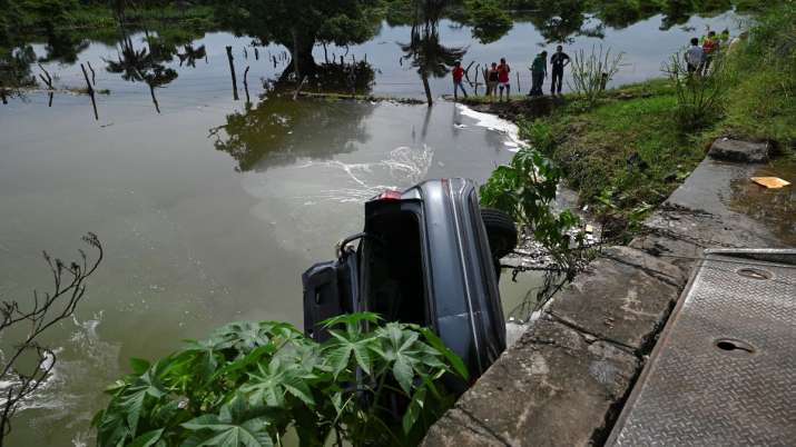 India Tv - The wreckage of a car whose driver lost his way fell into a sewage canal and died due to heavy rain 