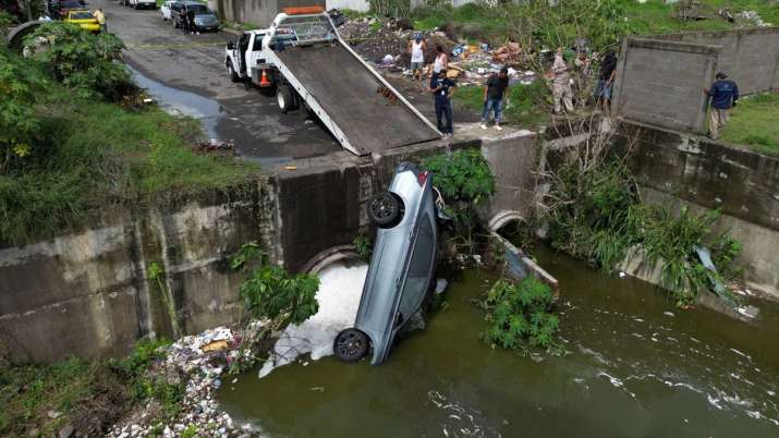 India Tv - The wreckage of a car whose driver lost his way fell into a sewage canal and died due to heavy rain 