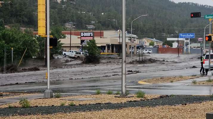 India Tv - View of vehicles stranded in rushing flood waters on a road in Ruidoso, New Mexico.