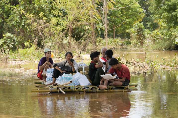 India Tv - Local residents wade through water in a makeshift