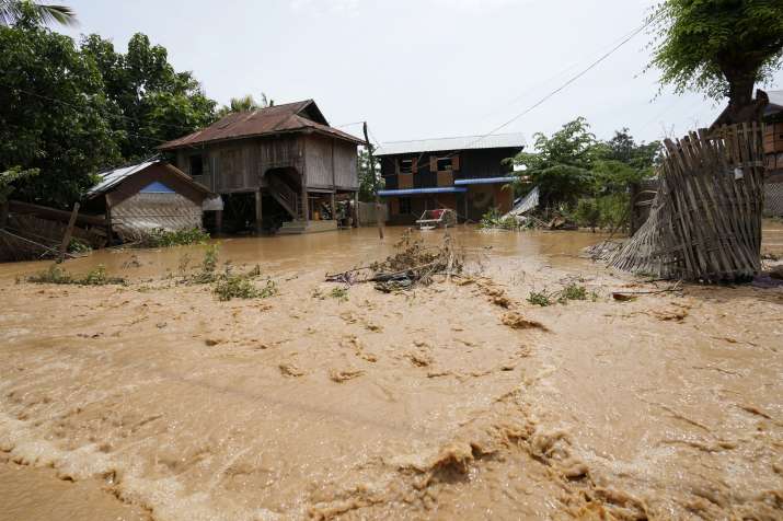 India Tv - Debris from half-submerged residences float on a flooded road in Naypyitaw