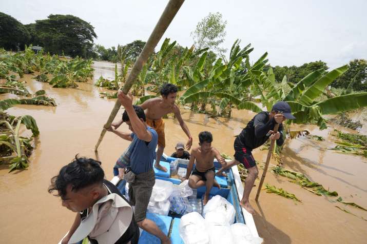 India Tv - Local residents wade through water