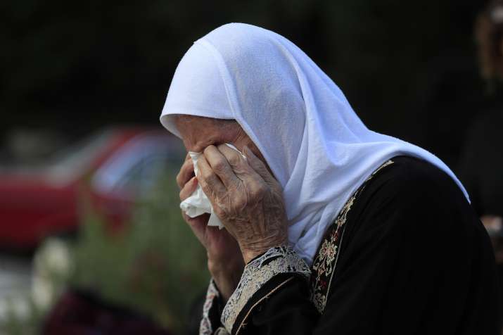 India Tv - Jamileh Ramadan, cries as she visits the grave of her granddaughter Julia Ramadan, who was killed on