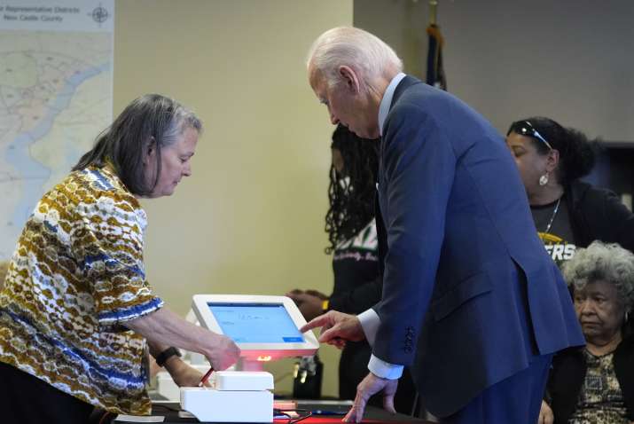 India Tv - Election official guiding President Joe Biden at the polling station.