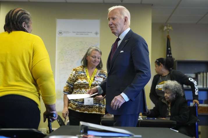 India Tv - Election official guiding President Joe Biden at the polling station.