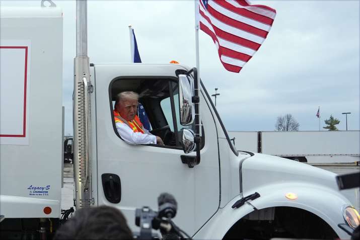 India Tv - Donald Trump talks to reporters as he sits in a garbage truck