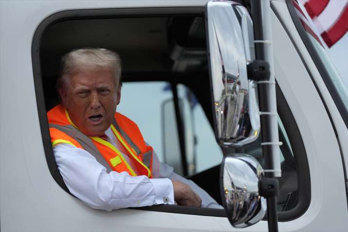 India Tv - Donald Trump boards garbage truck to draw attention to Biden remark