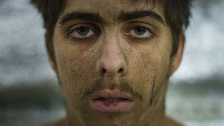 India Tv - A shell-shocked Ukrainian soldier of the Azov brigade sits at the stabilization point after arriving