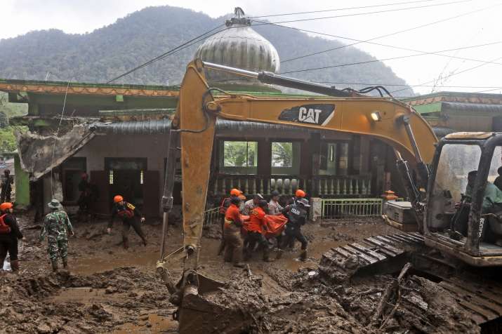 India Tv - Rescuers search for missing people after a landslide that killed a number of people and left some ot