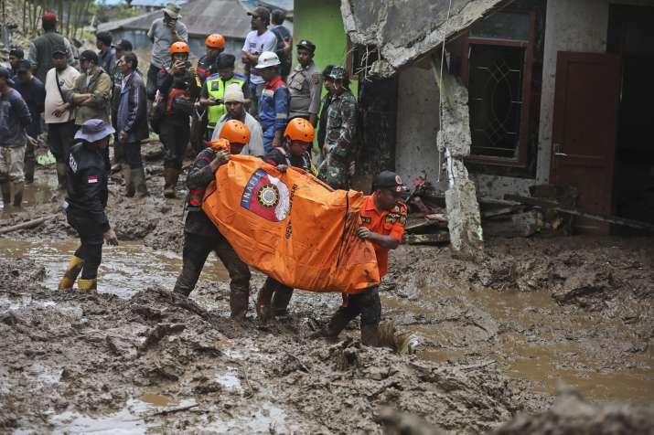 India Tv - Rescuers search for missing people after a landslide that killed a number of people and left some o