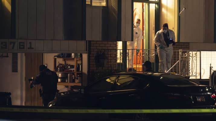 India Tv - Police investigate a crime scene where they say multiple family members were found dead inside a hom
